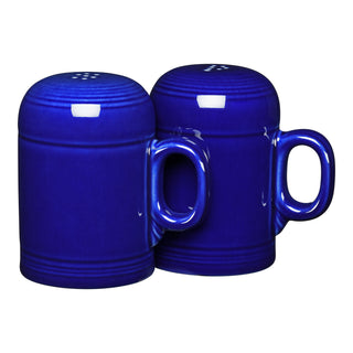 The Retired Fiesta 4 5/8 Inch Rangetop Large Salt and Pepper Shaker Set by Fiesta features two cobalt blue mug-shaped vitrified china shakers with handles, displayed side by side on a white background.