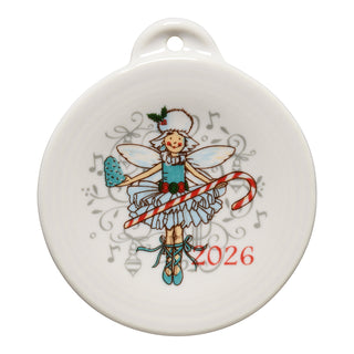 The Fiesta Nutcracker Sugar Plum Fairy 2026 Ornament features a smiling fairy in a blue dress with holly on her hat, holding a candy cane amid music notes. "2026" is printed in red on the lower right.