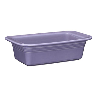 The Fiesta Lavender 10 3/4 Inch x 5 3/4 Inch Loaf Pan Baker (1.4 Quarts) features a glossy ceramic finish and slightly rounded corners, making it ideal for baking breads and casseroles. Oven safe and stylish, it's perfect for your kitchen.