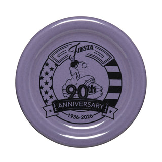A collector’s item: Fiesta Lavender 90th Anniversary 4 3/8 Inch Coaster and Mug Cover featuring a woman, Fiesta logo, Fiesta 90th Anniversary 1936-2026 text, and stars and stripes background.
