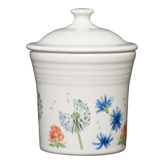 The Retired Breezy Floral 13 OZ Mini Canister (5 5/8") by Fiesta is a white ceramic canister with lid, featuring dandelion, blue cornflower, and red clover designs. Made from lead-safe china and dishwasher safe for easy cleaning.