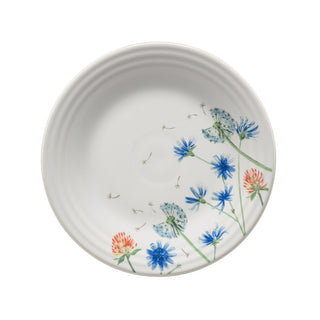 The Fiesta Retired Breezy Floral Classic Rim 9 Inch Luncheon Plate features blue and orange wildflowers with green stems along one edge on white vitrified china. Dishwasher safe for easy cleaning.