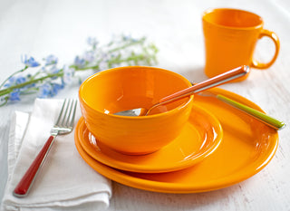 butterscotch place setting with flowers and white napki and fork placed next to it. 
