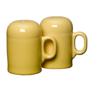 Retired Fiesta 4 5/8 Inch Rangetop Large Salt and Pepper Shaker Set by Fiesta—two yellow vitrified china shakers with handles, mug-shaped, made in the USA, displayed side by side on a plain white background.