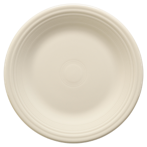 A plain, round, off-white ceramic plate with subtle concentric ridges along the rim, viewed from above against a white background.