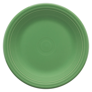 A round, solid green plate with a glossy finish and concentric circular ridges near the rim, viewed from above on a white background.