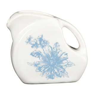 Introducing the Fiesta Botanical Floral Sky 5 OZ Mini Disk Pitcher—a white ceramic pitcher with a convenient side handle and spout. It features a blue botanical floral design on the front, is crafted in the USA, and showcases a rounded, modern artistic style inspired by botanical ceramic dinnerware.