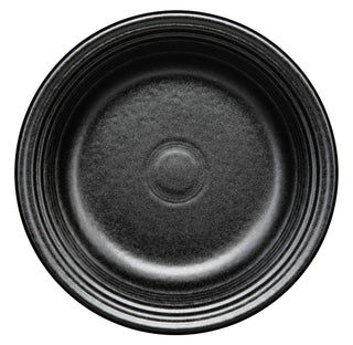 Black ceramic plate with a textured surface on a white background