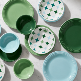 Fiesta Aegean Kaleido Circles dinnerware flat-lay in sage, forest green, teal, and ice blue on marble