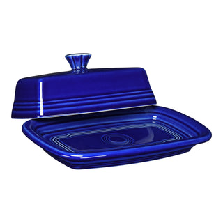 The Fiesta Retired Extra Large Covered Butter Dish in twilight is an 8 1/8 x 5 1/8 inch rectangular piece. Made in the USA, it features concentric circles, a knob handle on the lid, and is lead-safe china.