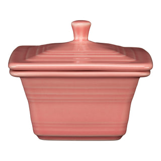 The Fiesta Retired Covered Box in peony is a square ceramic container (4 5/8" x 3 3/4") with a matching lid, knob handle, subtle horizontal lines, and a glossy finish.
