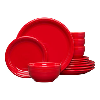 The Fiesta Bistro Coupe 12-Piece Dinnerware Set in scarlet, service for 4, features modern coupe plates and bowls stacked neatly with two plates and a bowl displayed in front—an ideal bistro-style place setting for any table.