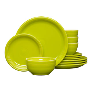 The Fiesta Retired Bistro Coupe 12-Piece Dinnerware Set in lemongrass includes plates and a bistro bowl, stacked on a white background. This lead-safe set, made in the USA, serves 4.