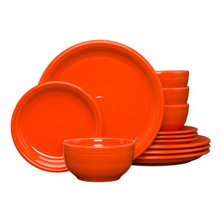 The Fiesta Bistro Coupe 12-Piece Dinnerware Set in poppy features plates and bowls stacked neatly against a white background, showcasing a modern coupe design for a vibrant table setting. Service for 4.