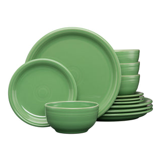 The Fiesta Bistro Coupe 12-Piece Dinnerware Set in meadow includes plates, bowls, and smaller dishes for 4. The set is displayed with stacked bowls and overlapping plates arranged together.