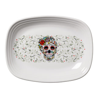 The Fiesta Retired SKULL AND VINE SUGAR 12 Inch Large Rectangular Platter, made in the USA, features a colorful sugar skull with floral and vine designs and a red flower on its forehead.