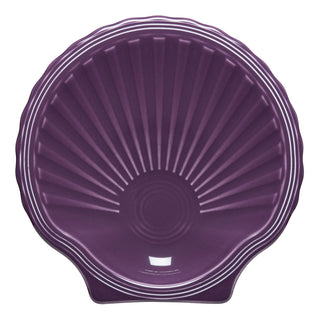 The Fiesta Retired Shell Shaped Plate 8 1/4 OZ in mulberry features radiating ridges, a glossy finish, and lead-safe ceramic—combining style and safety for your table.