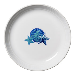 The Fiesta Retired Coastal Coupe 8 1/2 Inch Luncheon Bowl (26 OZ) features a blue seashell and two blue starfish in the center on white ceramic, viewed from above. Made in the USA.