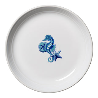The Fiesta Retired Coastal Seahorse Coupe 8 1/2 Inch Luncheon Bowl (26 OZ) features a white design with a blue seahorse and starfish illustration in the center, and is crafted from lead-safe china.