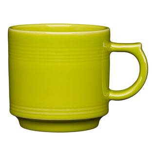 The Retired Fiesta 16 OZ Stackable Mug by Fiesta features a lemongrass hue, a handle, and subtle horizontal embossed lines near the rim. Made in the USA, it’s shown against a white background.