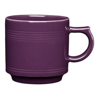 The Retired Fiesta 16 OZ Stackable Mug by Fiesta is a mulberry ceramic mug with a handle, three horizontal ridges near the rim, and a slightly raised base. Made in the USA, it’s shown against a white background.