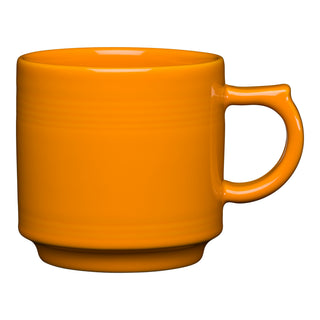 The Fiesta Retired 16 OZ Stackable Mug in butterscotch features a round handle, smooth glossy finish, and modern design. This lead-safe ceramic piece is crafted with care in the USA and photographed against a white background.
