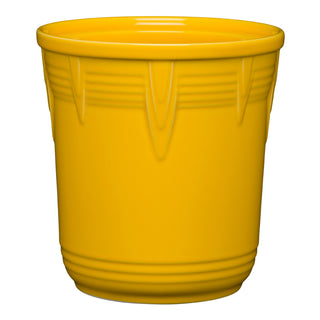 The Retired Fiesta 7 Inch Chevron Utensil Crock by Fiesta, in daffodil yellow, features vertical chevron designs near the rim and smooth sides. Use it as a stylish flower pot, utensil holder, or kitchen canister; shown on a white background.