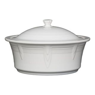 The Fiesta Large 10 Inch Round Covered Casserole, 2.8 Quart, in white features a subtle raised pattern, a fitted lid with knob handle, and is oven safe. Proudly made in the USA.