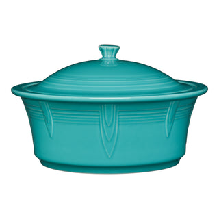 The Fiesta Large 10 Inch Round Covered Casserole (2.8 Quart) in turquoise is oven safe, made in the USA, and features an embossed art deco-inspired pattern with a matching knob-handled lid.