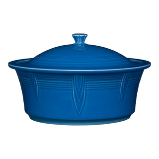The Fiesta Large 10 Inch Round Covered Casserole (2.8 Quart) in lapis features decorative raised patterns, comes with a matching lid, and is oven safe—perfect for your kitchen.