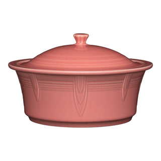 The Fiesta Large 10 Inch Round Covered Casserole (2.8 Quart) in peony features a knob-handled lid and subtle embossed side patterns. Made in the USA, this pink ceramic dish is oven safe for easy cooking and serving.