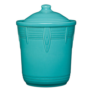 The Retired Fiesta 2 Quart Medium Chevron Canister by Fiesta comes in turquoise, with a lid, vertical chevron patterns, and ridges on the rim and base. Its glossy finish and modern design make it a stylish kitchen storage piece.