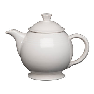 The Retired Fiesta 44 OZ Covered Teapot by Fiesta, in white, features a curved spout, round body, large handle, and fitted lid, made from lead-safe china and shown on a plain white background.