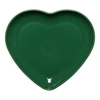 The Retired Fiesta 9 Inch Heart Shaped Plate by Fiesta features a jade green ceramic design with concentric circles at the center, made in the USA and shown here on a white background.