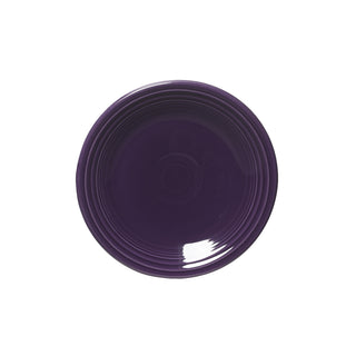 The Fiesta Retired Classic Rim 7 1/4 Inch Salad Plate in Plum is a round, glossy ceramic plate with concentric raised rings near the edge, made in the USA and shown on a white background.