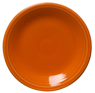 The Fiesta Retired Classic Rim 7 1/4 Inch Salad Plate in tangerine features a glossy finish and concentric patterns near the rim, shown from a top-down view. Proudly made in the USA.