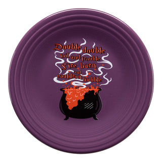The Fiesta Retired Halloween Cauldron Classic Rim 9 Inch Luncheon Plate, made in the USA, features a purple vitrified china design with a black cauldron, orange potion, swirling steam, and the words: Double double toil and trouble.
