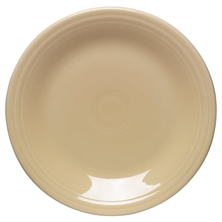 The Fiesta Retired Classic Rim 7 1/4 Inch Salad Plate is an ivory, round ceramic plate with a glossy surface and subtle ridges near the rim, made in the USA and shown from above.