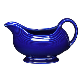 The retired Fiesta 18 1/2 oz Gravy Sauceboat in twilight is a handled piece with a spout, ideal for serving sauces. Shown on a white background.