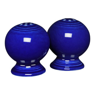 A retired Fiesta 2 5/8 inch salt and pepper shaker set in twilight color, from the Fiesta brand, with a glossy finish, shown side by side on a white background.