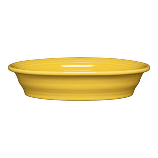 The Fiesta Retired Oval Baker, 10 1/4 in, 40 oz, features a sunflower-yellow finish and smooth, glossy ceramic design with gently flared rim, displayed against a white background.