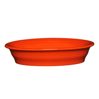 A poppy-colored Fiesta Retired Oval Baker, 10 1/4 in, 40 oz, with a smooth surface and wide rim, displayed side view against a white background.