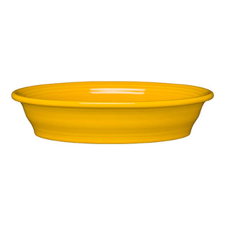 The Fiesta Retired Oval Baker, 10 1/4 in, 40 oz, in bright daffodil yellow ceramic, features a wide rim and shallow shape, shown against a plain white background.
