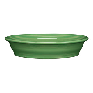 The Fiesta Retired Oval Baker, 10 1/4 in, 40 oz, in meadow green features a smooth finish and slightly flared rim. This shallow ceramic baker is oven safe and photographed against a white background.