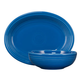 The Fiesta 2-Piece Serve Set in lapis includes an 11 5/8-inch oval platter and a 38 oz Bistro Bowl, both featuring subtle concentric circle patterns inspired by classic Fiesta dinnerware.