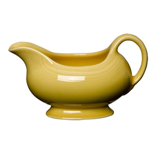 A Fiesta Retired 18 1/2 OZ Gravy Sauceboat in sunflower yellow, featuring a curved handle and wide spout, perfect for serving sauces. Displayed on a white background.