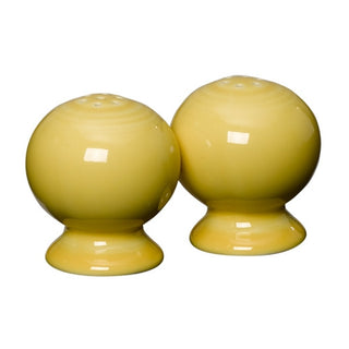 Two round, sunflower-colored ceramic shakers by Fiesta, each 2 5/8 inches tall, displayed on a white background. This retired Fiesta salt and pepper shaker set brightens any table and complements the Fiesta Dinnerware collection.