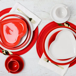 Scarlet and White heart plates with gold silverware on regular plates and a white table