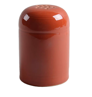 The Retired Fiesta Cheese Shaker by Fiesta comes in paprika ceramic with a glossy, chip-resistant finish and small top holes—perfect for shaking spices like salt or pepper. Its cylindrical shape ensures easy handling.